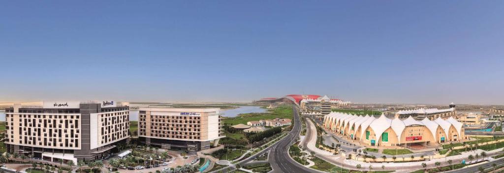 an aerial view of a city with buildings at Radisson Blu Hotel, Abu Dhabi Yas Island in Abu Dhabi