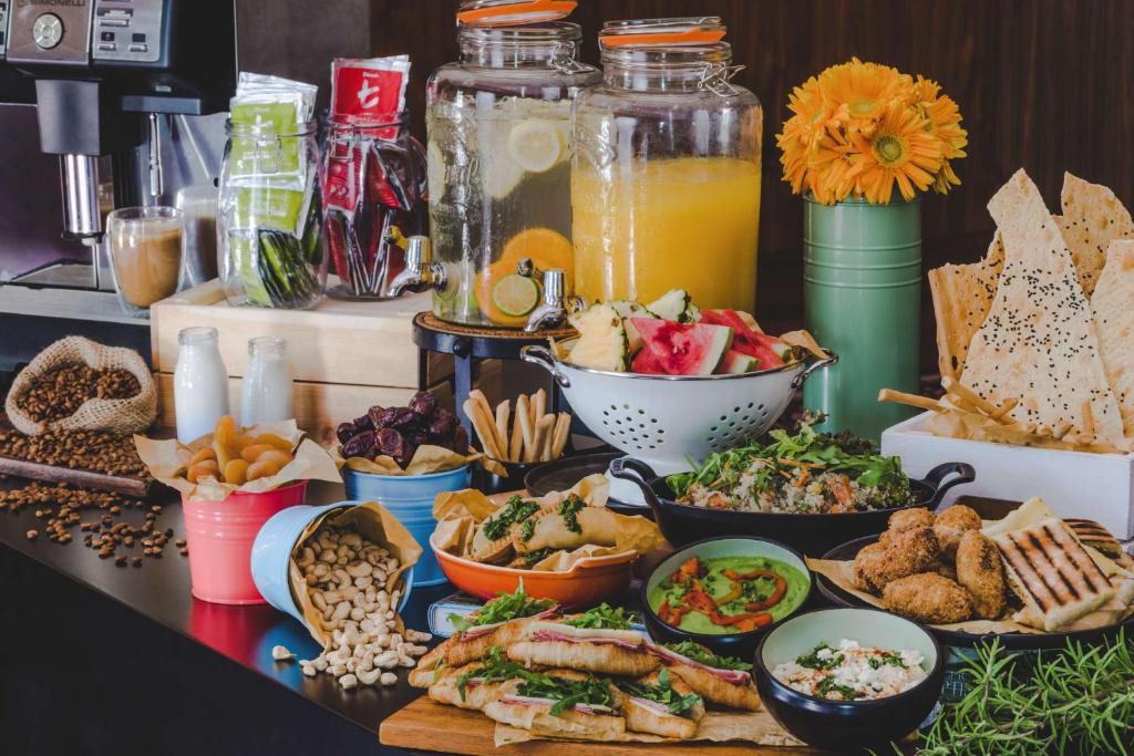 a buffet of food with bowls of food on a table at Radisson Blu Hotel, Abu Dhabi Yas Island in Abu Dhabi