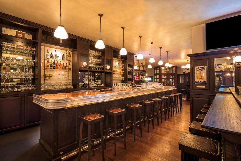a bar with a row of stools in a room at Radisson Blu Hotel, Abu Dhabi Yas Island in Abu Dhabi