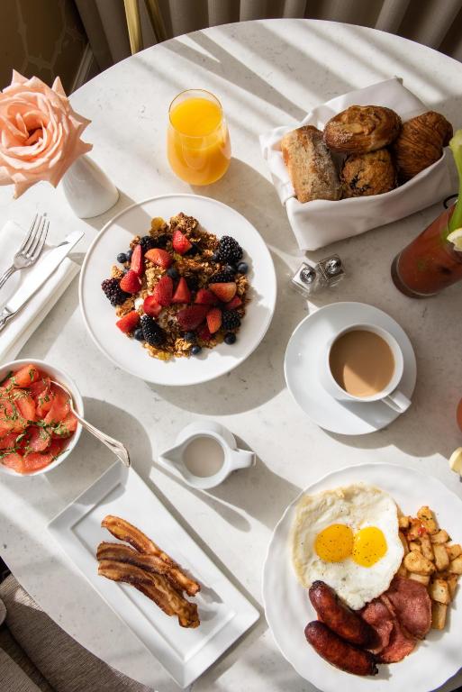 a table topped with plates of breakfast food and coffee at The Rittenhouse Hotel in Philadelphia