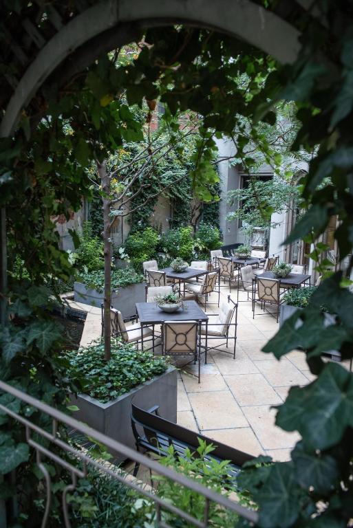 a group of tables and chairs in a garden at The Rittenhouse Hotel in Philadelphia