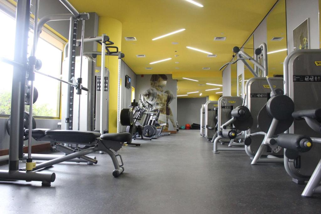 a gym with rows of exercise equipment and a skeleton at Park Inn by Radisson Abu Dhabi Yas Island in Abu Dhabi
