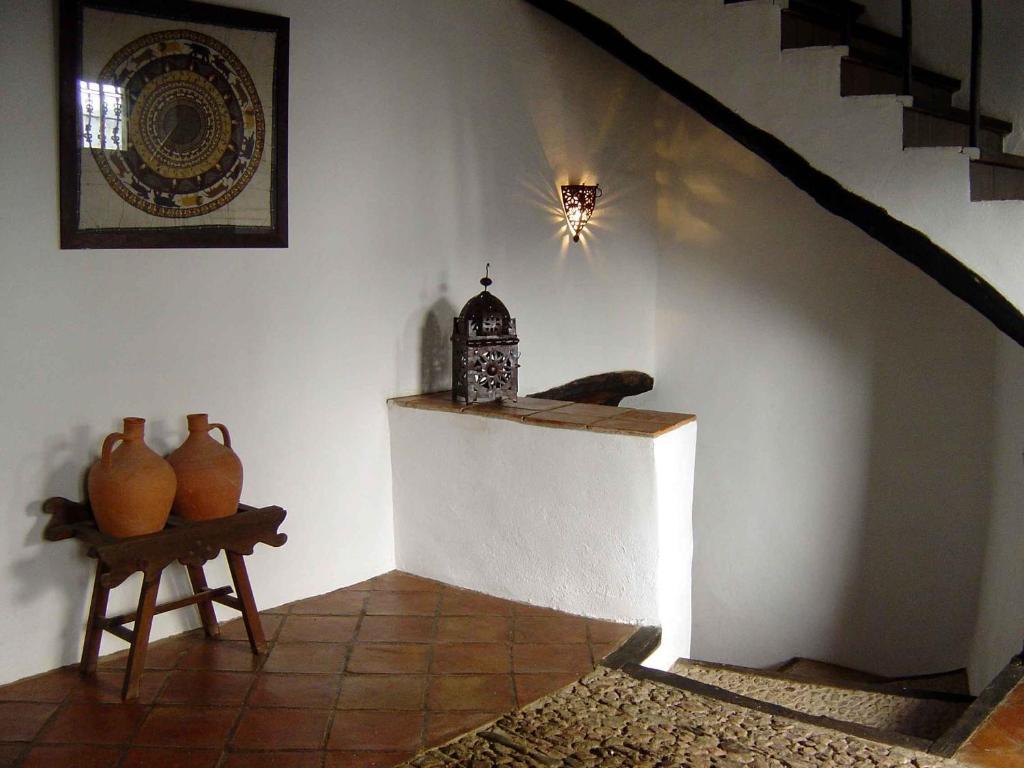 Castaño de Robledo的住宿－卡斯塔諾旅館，一间设有花瓶和桌子的楼梯的房间