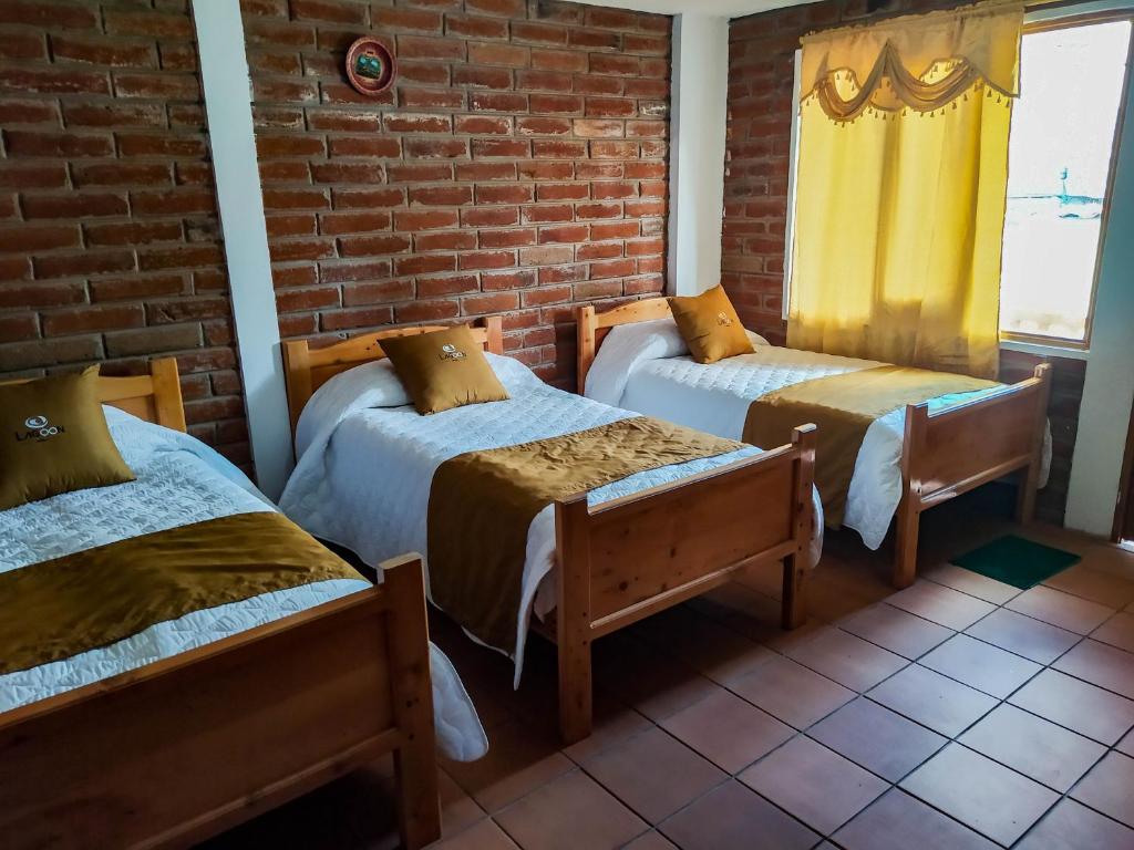 Postel nebo postele na pokoji v ubytování Lagoon Hotel Chugchilan