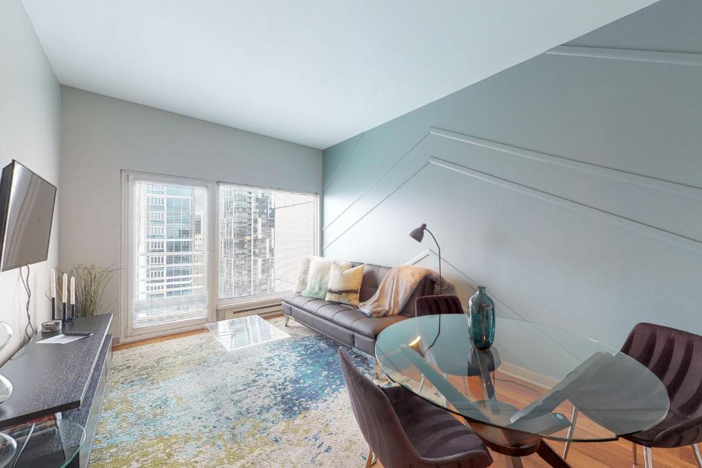 a living room with a glass table and a couch at Newmark Tower in Seattle