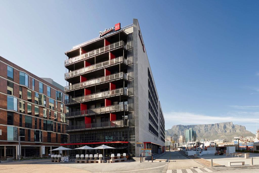 a tall building with red windows and a hotel at Radisson RED Hotel V&A Waterfront Cape Town in Cape Town