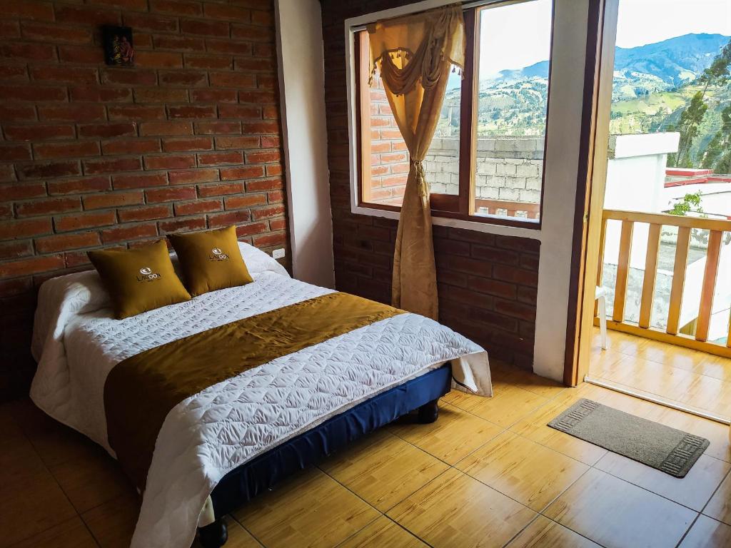 Postel nebo postele na pokoji v ubytování Lagoon Hotel Chugchilan