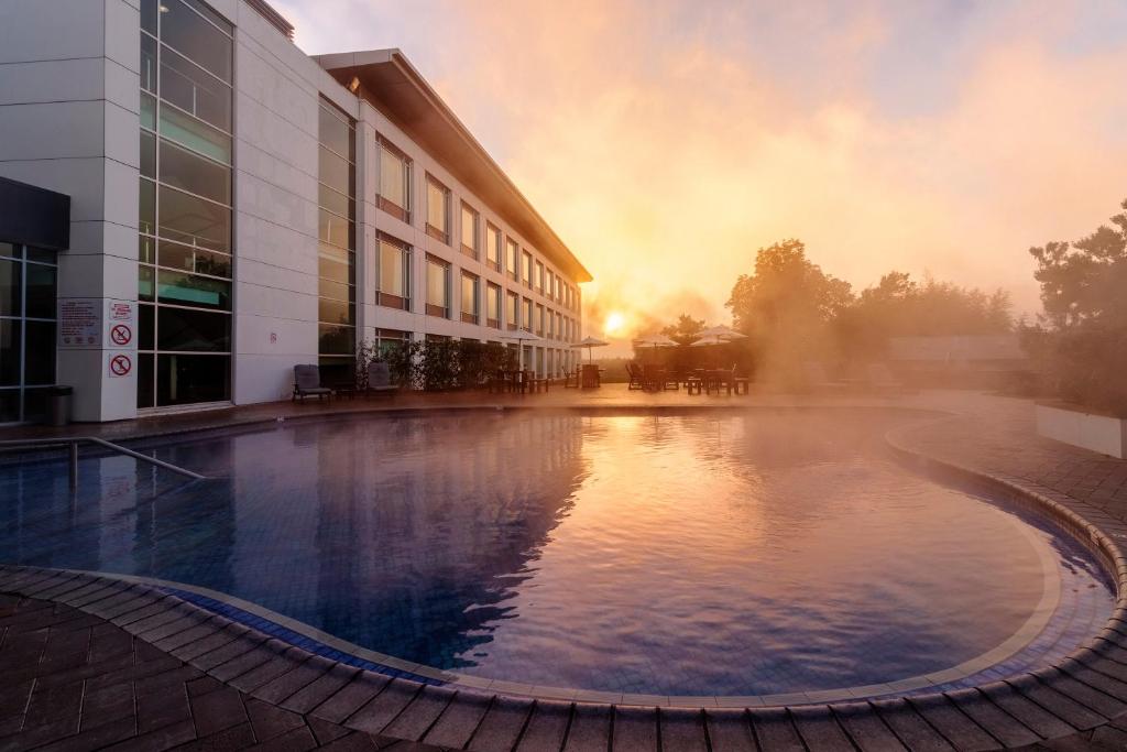a large pool of water in front of a building at Rydges Rotorua formerly known as Holiday Inn Rotorua in Rotorua