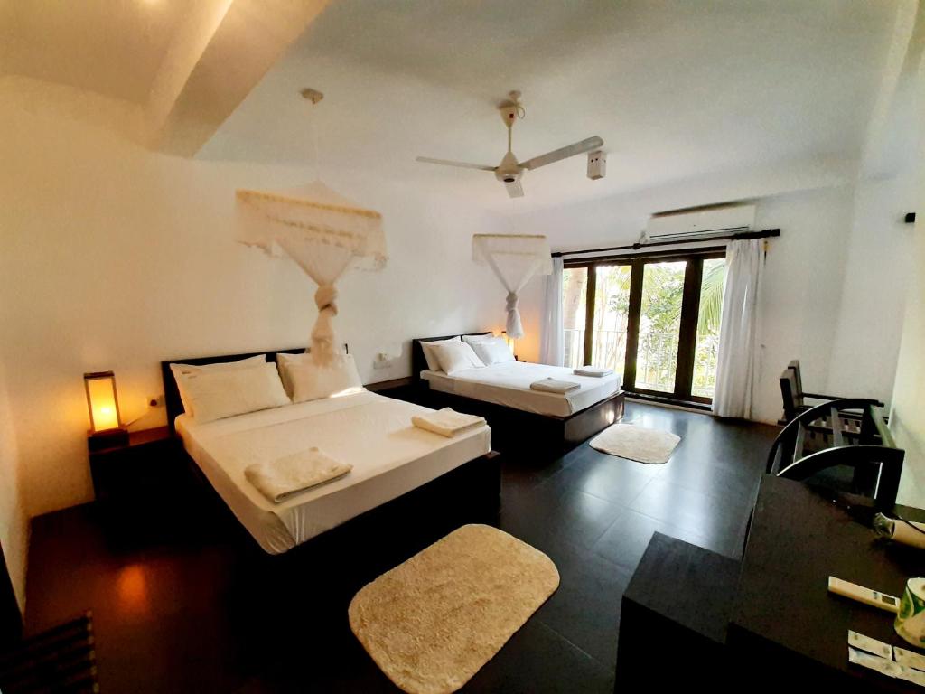 Postel nebo postele na pokoji v ubytování Lakmini Lodge Sigiriya