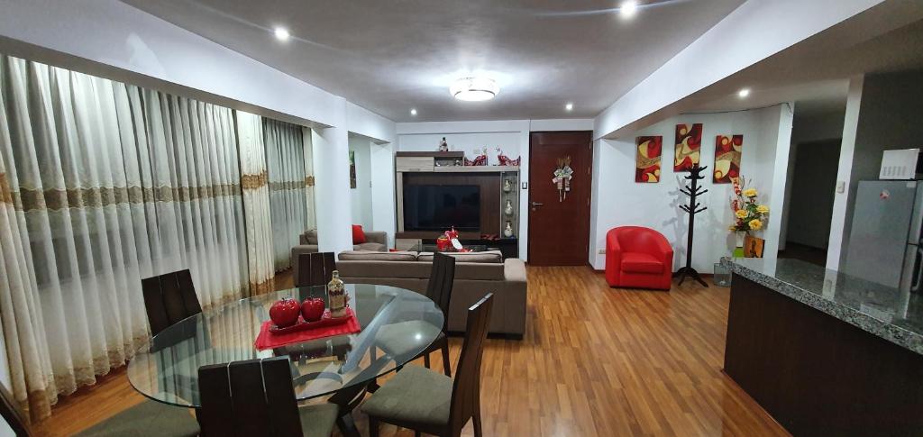 a living room with a glass table and a couch at Cusco Apartment MVP in Cusco