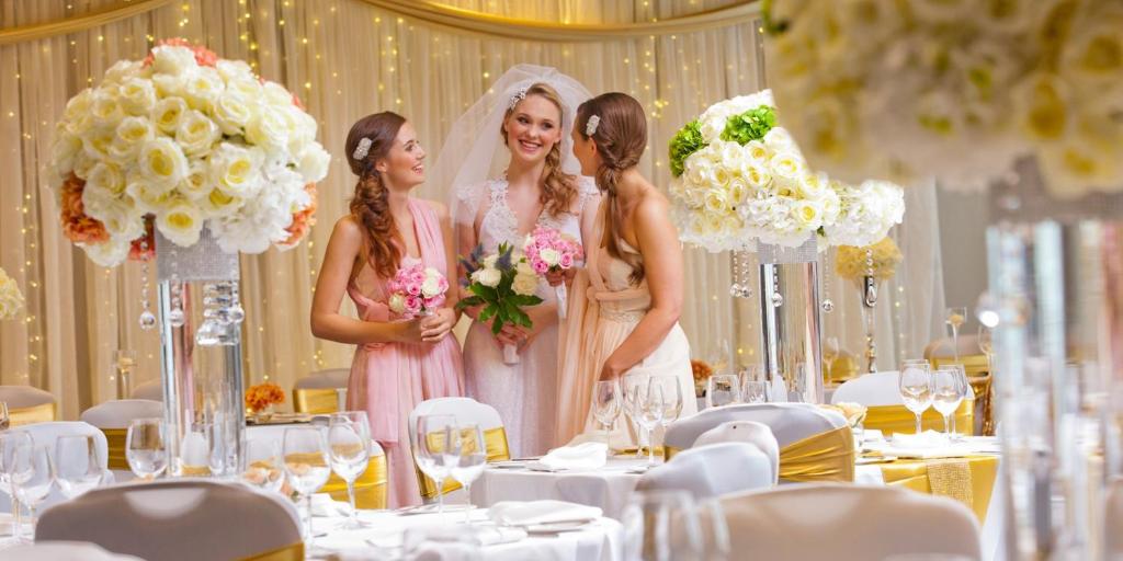 a group of three women standing in a wedding marquee at Crowne Plaza Aberdeen Airport by IHG in Dyce