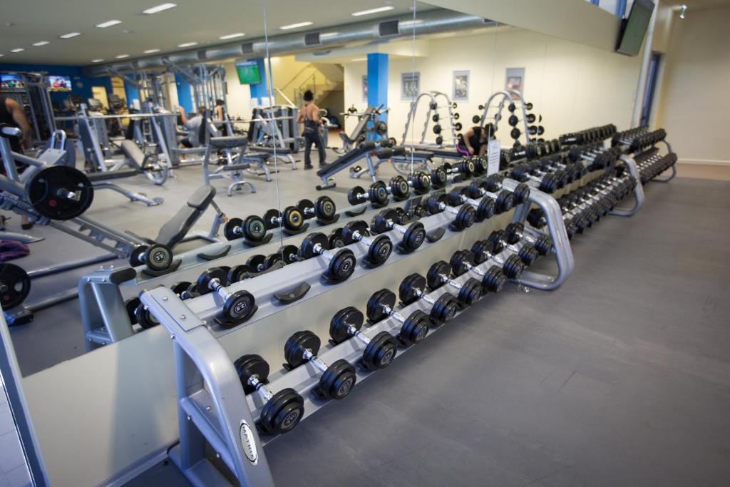 a gym with rows of dumbbells on display at Crowne Plaza Alice Springs Lasseters, an IHG Hotel in Alice Springs