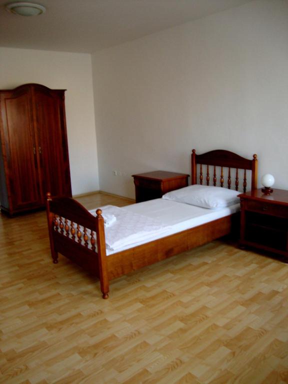 a bedroom with a bed and a wooden floor at Penzion Aviatik in Čáslav