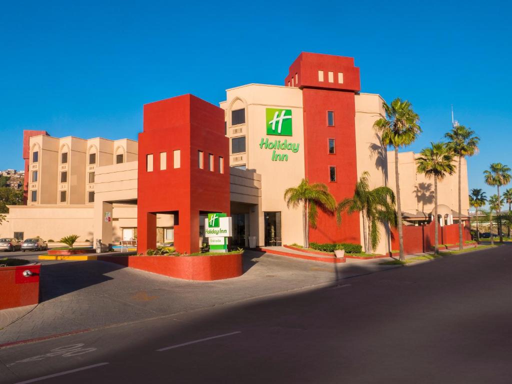 a large building with a sign on the side of it at Holiday Inn Tijuana Zona Rio, an IHG Hotel in Tijuana