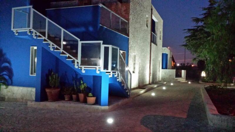 a blue building with a staircase on the side of it at Bed and Breakfast Fly in Bari