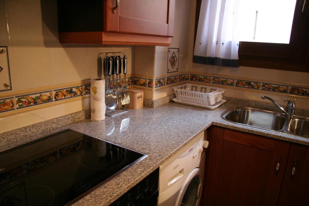 A kitchen or kitchenette at Apartamentos La Iglesia