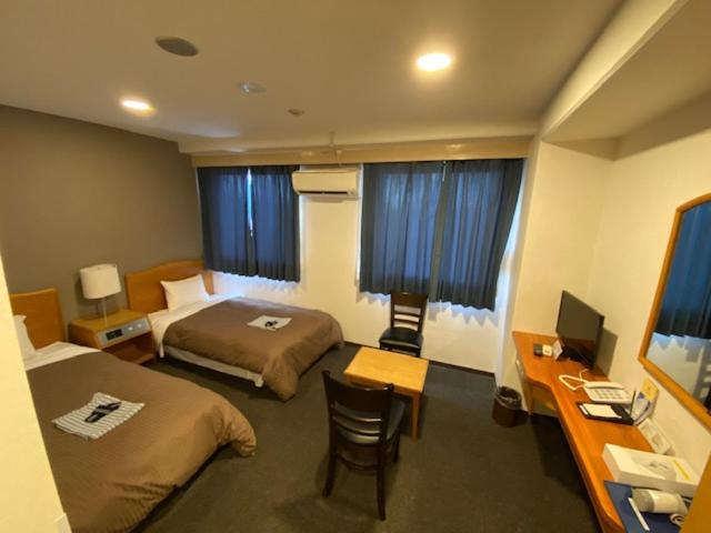 Postel nebo postele na pokoji v ubytování Hotel New Yutaka