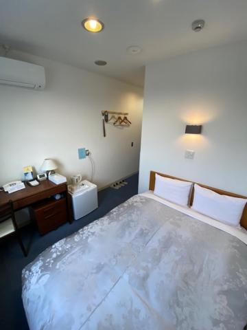 Postel nebo postele na pokoji v ubytování Hotel New Yutaka
