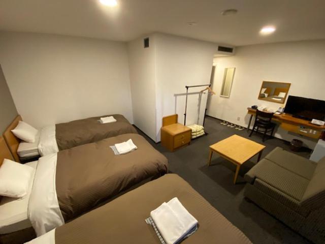 Postel nebo postele na pokoji v ubytování Hotel New Yutaka