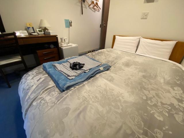 Postel nebo postele na pokoji v ubytování Hotel New Yutaka