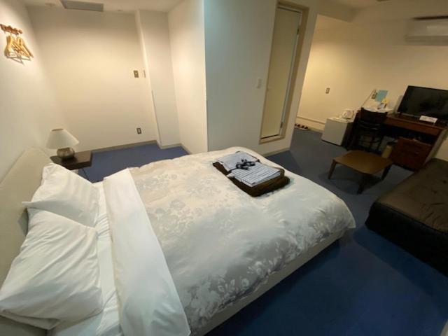 Postel nebo postele na pokoji v ubytování Hotel New Yutaka