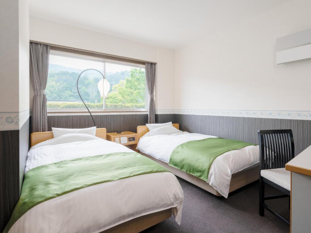 Voodi või voodid majutusasutuse Amano Hashidate Hotel toas
