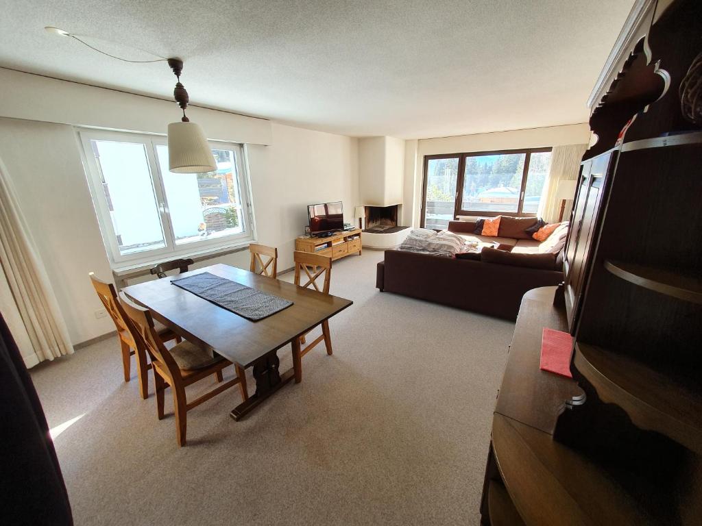 a living room with a table and a couch at Apartment in Lenzerheide in Lenzerheide