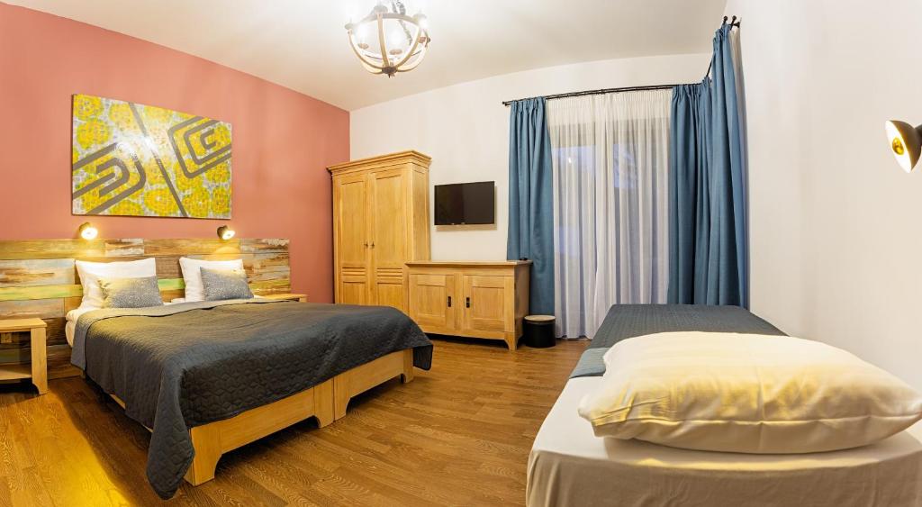 Postel nebo postele na pokoji v ubytování Butikhotel Visegrád