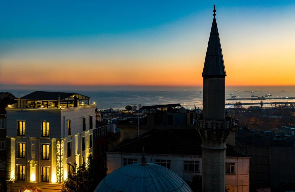 a view of a city with a clock tower at sunset at Interstar Hotel in Istanbul