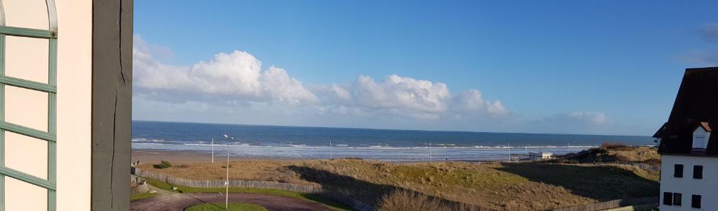 a view of the ocean from a building at Bord de plage, thalasso et vue mer ! in Cabourg