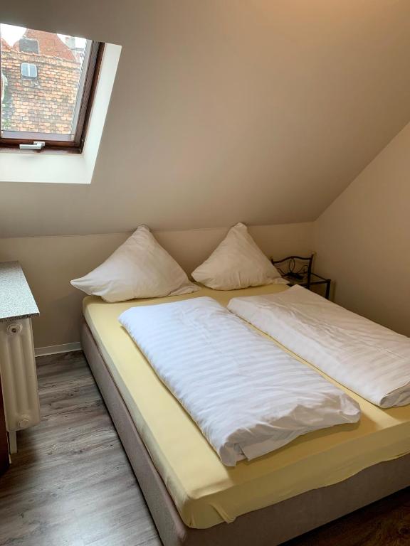 Postel nebo postele na pokoji v ubytování Gästehaus Präsenzhof