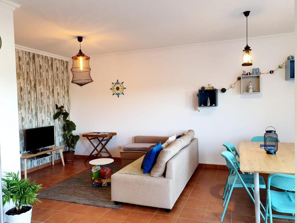 a living room with a couch and a table at Steersman House in Aljezur