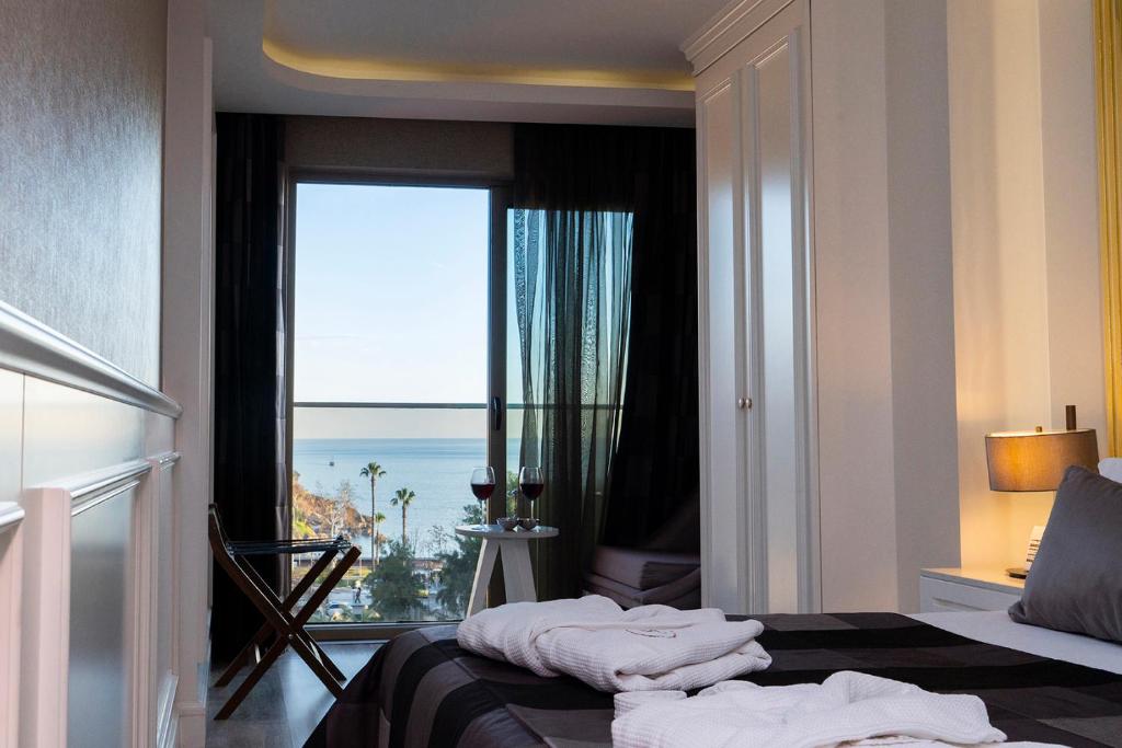 a bedroom with a window with a view of the ocean at Sky Kamer Hotel Antalya in Antalya