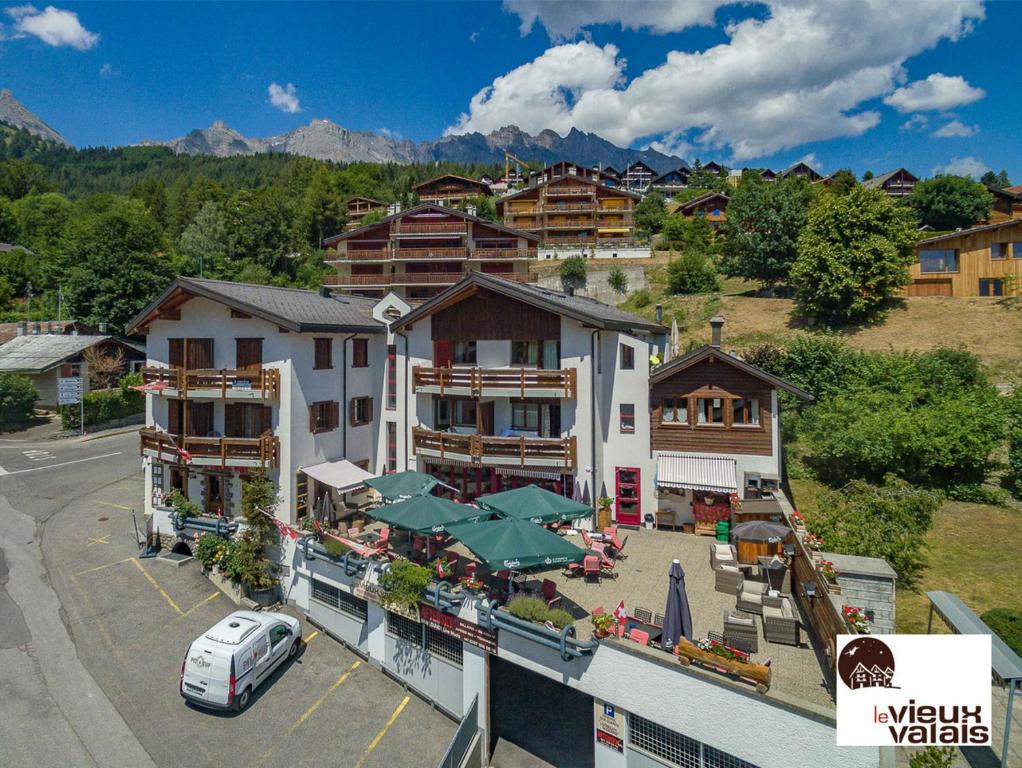 an aerial view of a hotel with a parking lot at Le Vieux Valais in Ovronnaz