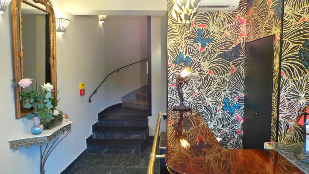a staircase with a painting of a cat on a wall at Hotel Relais Du Postillon in Antibes