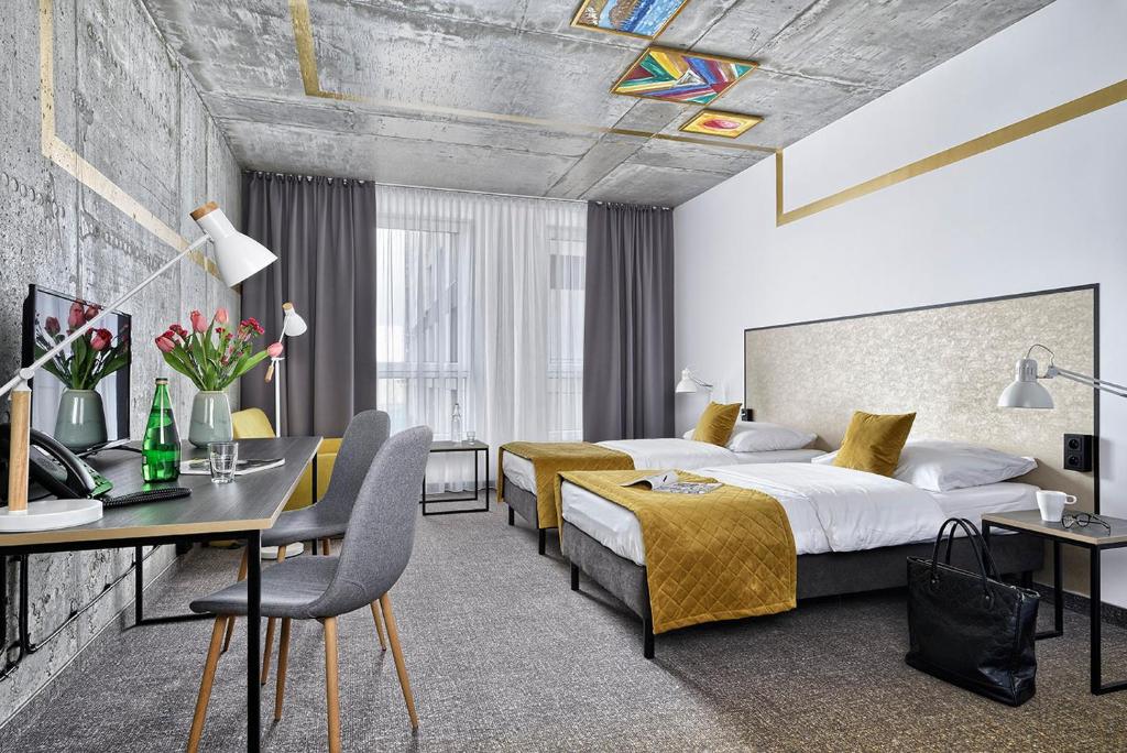 Cette chambre comprend deux lits et un bureau. dans l'établissement Hotel Arche Geologiczna, à Varsovie