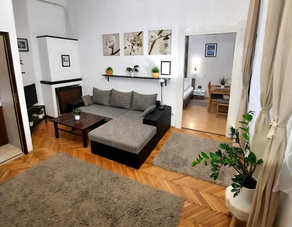 a living room with a couch and a table at Central Gold Apartment in Budapest