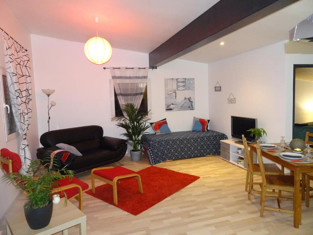 a living room with a couch and a table at Fab Studio in Granges