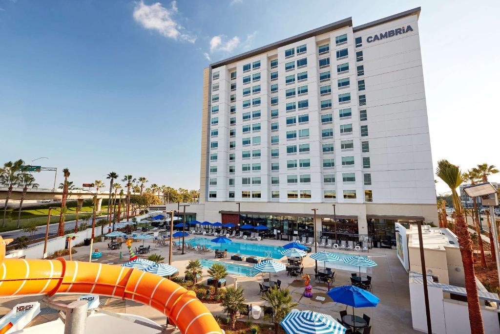 a hotel with a water slide in front of a resort at Cambria Hotel & Suites Anaheim Resort Area in Anaheim