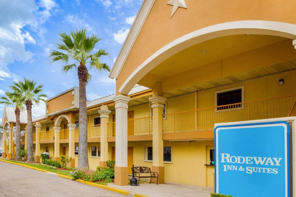 a hotel with a sign in front of a building at Rodeway Inn & Suites Houston near Medical Center in Houston