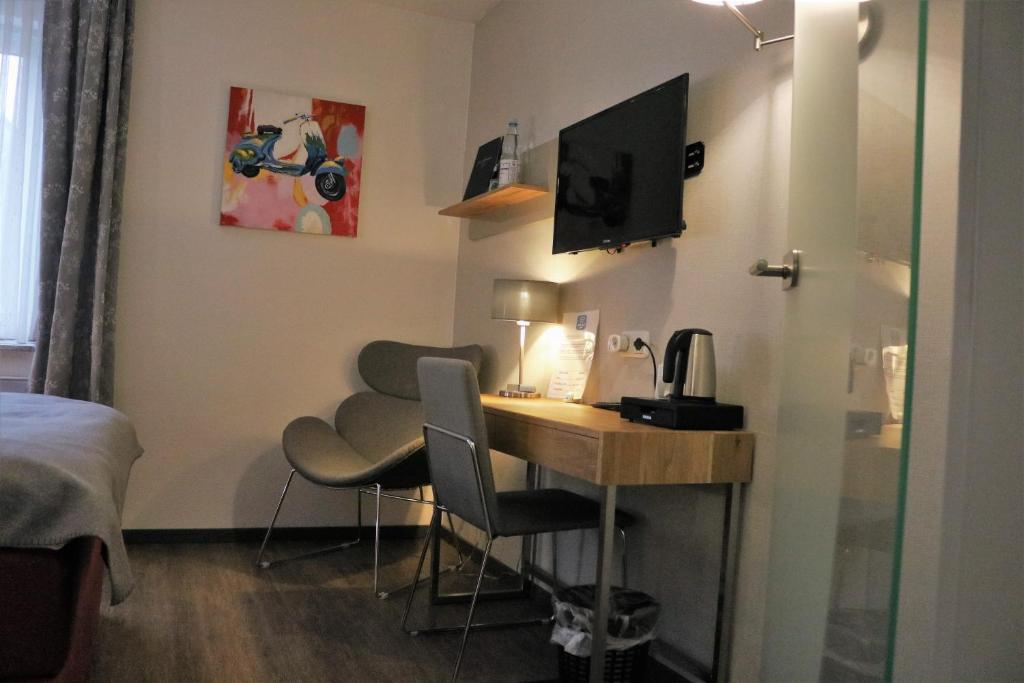 Postel nebo postele na pokoji v ubytování Hotel Schmerkötter