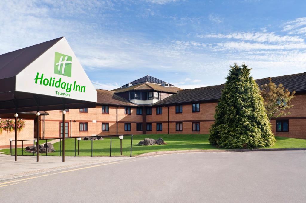 a hotel with a sign in front of a building at Holiday Inn Taunton M5, Jct25 by IHG in Taunton