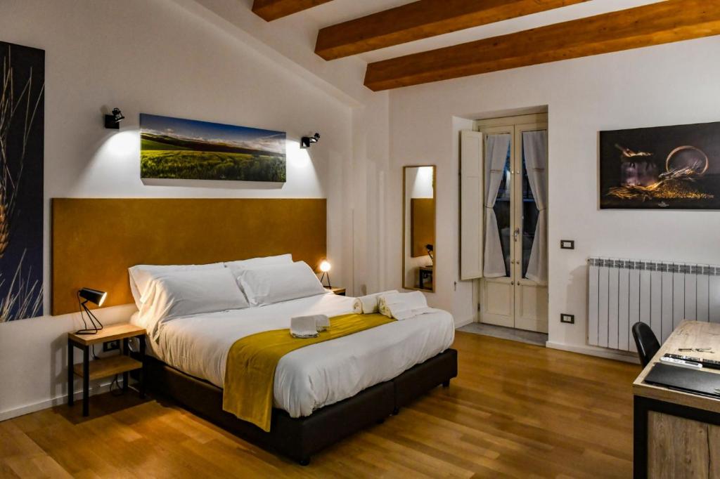 a bedroom with a large bed in a room at Ballarooms B&B Palermo Centro in Palermo