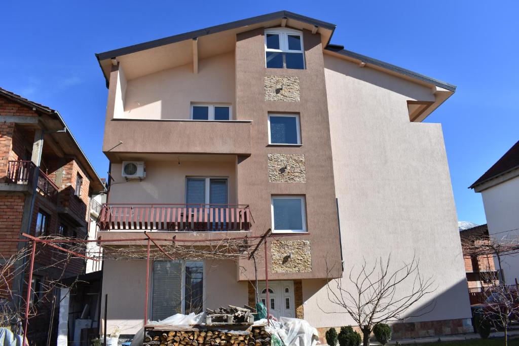 a tall building with a balcony on it at Vila Arsovi in Ohrid