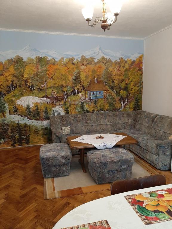 a living room with a large painting on the wall at Alex-Gabriel in Sibiu