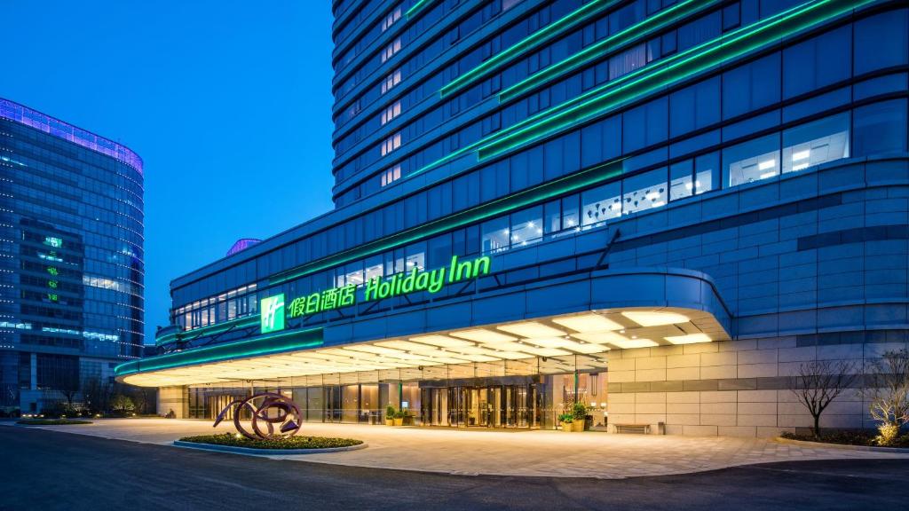 a building with a sign on the side of it at Holiday Inn Suzhou Taihu Lake by IHG in Suzhou