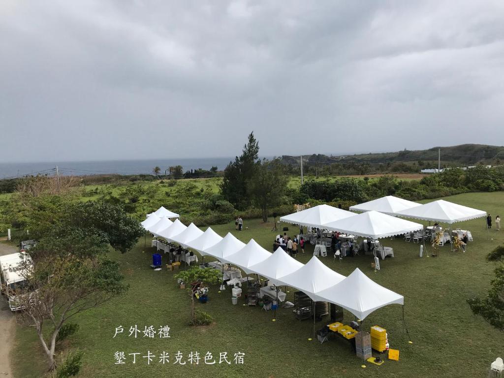 an overhead view of white tents in a field at Kenting COMIC B&amp;B in Hengchun South Gate
