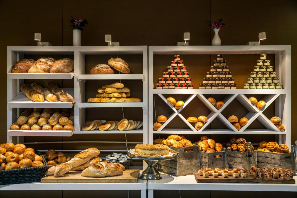 a bakery filled with lots of different types of bread at Crowne Plaza Tel Aviv City Center, an IHG Hotel in Tel Aviv