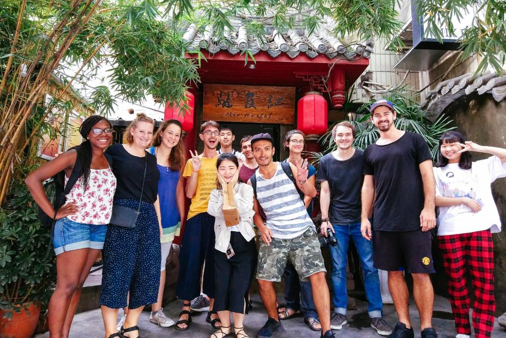 a group of people standing in front of a building at Chengdu Mix Hostel Courtyard Poshpacker (Wenshu Monastery) in Chengdu