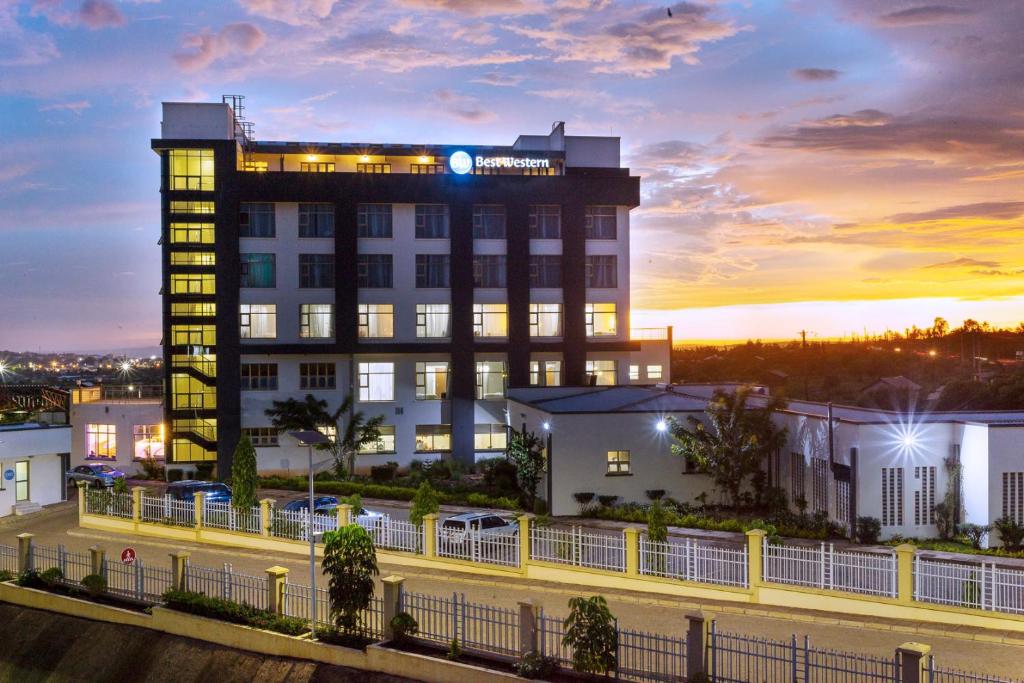 a building with a clock on the top of it at Best Western Kisumu Hotel in Kisumu